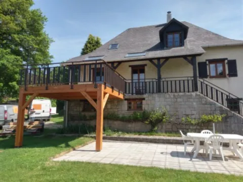 Terrasse extension de balcon en mélèze avec garde-corps aluminium thermolaqué